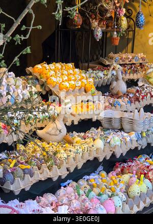 Colorful decorated easter eggs on display at a market stall. Stock Photo
