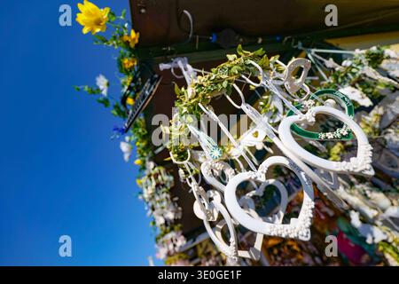 White heart decorations hanging against blue sky Stock Photo