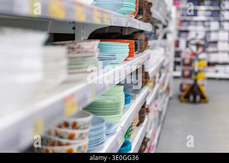 Ceramic plates and bowls on supermarket shelves. Stock Photo