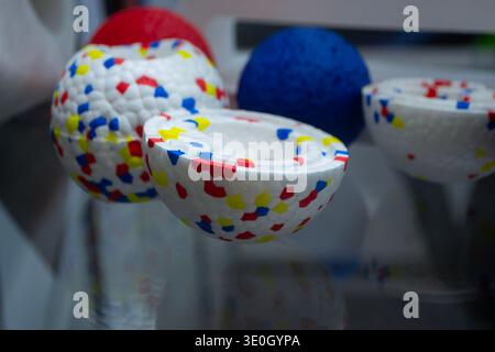 Example object from material expanded polypropylene EPP, universal foam. Durable foam white dog ball toy close-up. Shape of connected balls, multi-colored pattern. New modern industrial technologies. Stock Photo