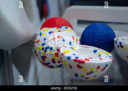 Example object from material expanded polypropylene EPP, universal foam. Durable foam white dog ball toy close-up. Shape of connected balls, multi-colored pattern. New modern industrial technologies. Stock Photo