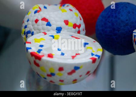 Example object from material expanded polypropylene EPP, universal foam. Durable foam white dog ball toy close-up. Shape of connected balls, multi-colored pattern. New modern industrial technologies. Stock Photo