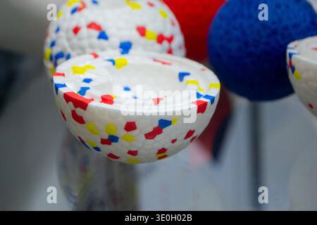 Example object from material expanded polypropylene EPP, universal foam. Durable foam white dog ball toy close-up. Shape of connected balls, multi-colored pattern. New modern industrial technologies. Stock Photo