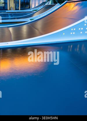 A minimalist view of flowing water reflecting warm golden light at night. The image conveys abstract beauty, luxury, and modern landscape lighting. Hi Stock Photo