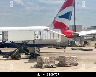 London, England, UK - 20 May 2025: Air freight on pallets waiting to be loaded into a British Airways jet. Stock Photo