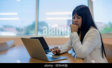 Business decision making and financial analysis at desk. Office work pressure and deadline stress for employees.Mental health at work and professional Stock Photo