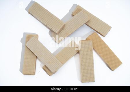 Crispy vanilla wafer cookies, a popular sweet snack or dessert, scattered on a clean white surface presenting a simple composition Stock Photo