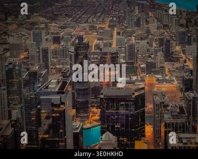 Aerial night view of downtown Chicago skyline with illuminated skyscrapers Chicago River and Lake Michigan in background Illinois USA Stock Photo