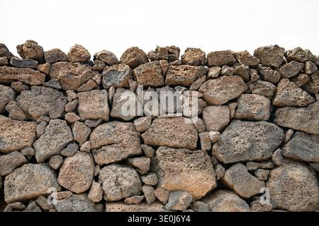 Background of stone wall texture. Close up of stone wall texture. Stock Photo