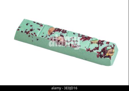 Green craft chocolate bar with dried berry pieces on white background artisan handmade gourmet confectionery. Stock Photo
