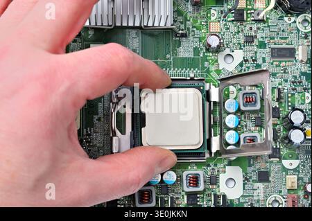 Installing a central processing unit into a computer motherboard socket for upgrade or repair Stock Photo