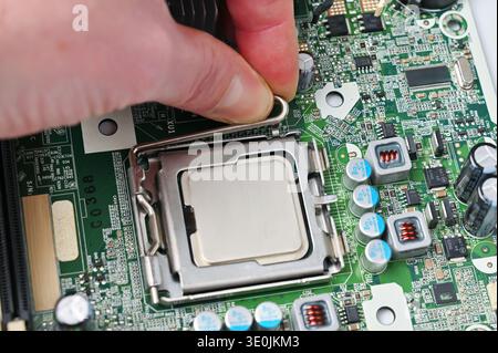 Installing a central processing unit into a computer motherboard socket for upgrades or repairs Stock Photo