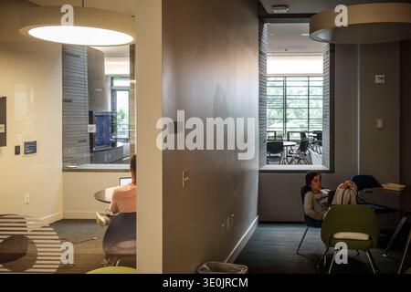 Students studying on laptops in the modern student union building at Georgetown University, Washington DC, USA Stock Photo