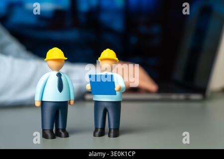 Two engineers in hard hats and holding blueprints. Architecture planning and construction management. Engineering teamwork in building projects, infra Stock Photo