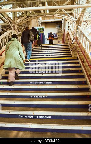 Keep left on stairs leading from railway station platform Stock Photo