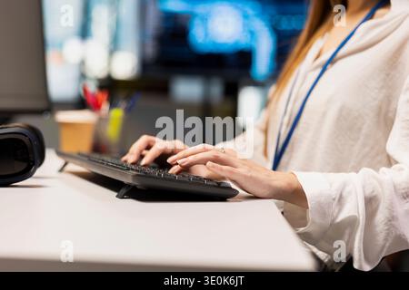 Close up of engineer writing code, developing machine learning APIs. IT expert typing on keyboard in office, troubleshooting software errors using artificial intelligence tech Stock Photo