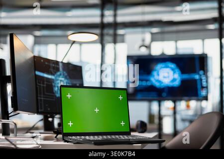 Mockup laptop in AI startup workspace leveraging machine learning technology to automate scripts. Empty office with AI tools running on isolated screen notebook device to review code files for bugs Stock Photo