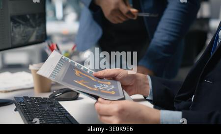 Team of diverse engineers partners evaluating solar performance in high tech industrial factory, focusing on sustainable energy development. Alternative power for modern operations. Camera B. Stock Photo