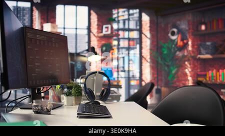 Office desktop setup includes monitors displaying terminal interfaces and AI systems. The self learning model showcases deep learning innovations and modern computing technologies. Stock Photo