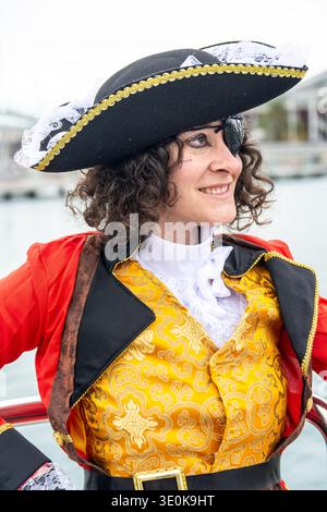Woman smiling while wearing a pirate captain costume Stock Photo
