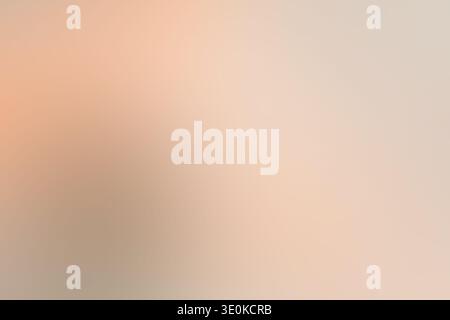 Blurred abstract background showing a smooth gradient of soft peach, tan, and cream colors creating a warm abstract surface Stock Photo