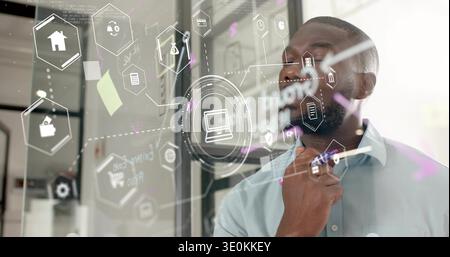 Studying man wearing light-blue shirt writing on glass partition with laptop icon, copy space Stock Photo