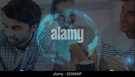 Sitting team around table in kitchen, checked shirt, holding mugs, stylus under blue globe overlay Stock Photo