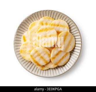 Top view of Japanese salad rice crackers (senbei) on a grey plate, isolated on white background Stock Photo
