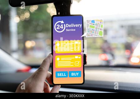 Close-up of a smartphone mounted in a car displaying a 24-hour delivery service app with map, order list, and buy-sell buttons, representing mobile co Stock Photo