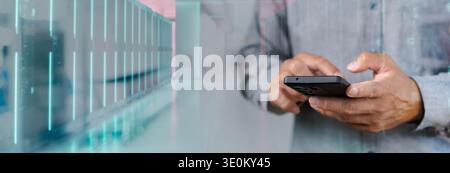 Businessperson using smartphone with data center server overlay, representing mobile IT monitoring, cloud computing, remote administration, cybersecur Stock Photo