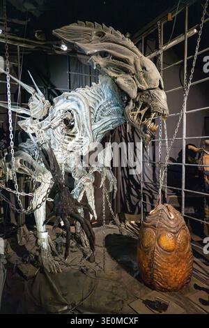 Lyon, France - 7 Jan 24: Detailed xenomorph queen creature model with alien egg on display at Musée Cinéma et Miniature in Lyon, France. Stock Photo