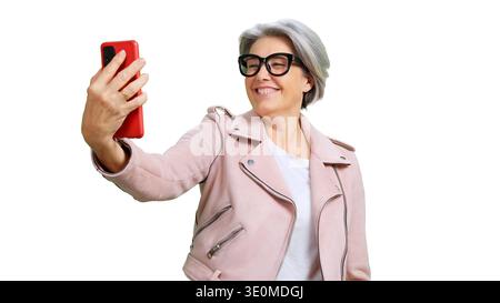 Senior woman using smartphone taking happy selfie Stock Photo