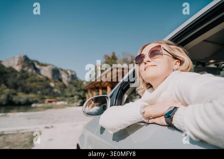 Woman in Sunglasses Enjoying a Road Trip Stock Photo