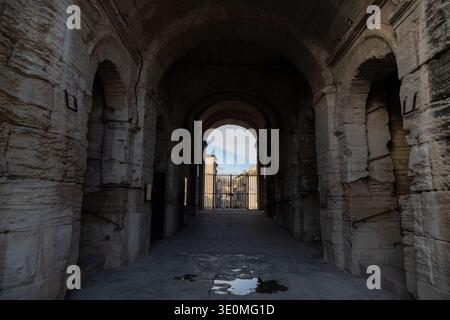 View through a vaulted stone tunnel and archway inside the Roman amphitheatre in Arles, Provence-Alpes-Cote d'Azur, France. Stock Photo