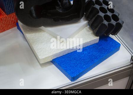 Products made from foamed polymers expanded polypropylene EPP and expanded polystyrene EPS. Model of dense and lightweight material, universal foam. New modern technologies. Industrial manufacturing Stock Photo