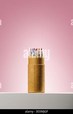 Colored pencils in cardboard case on pink Stock Photo