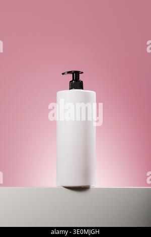 White pump dispenser bottle on pink background Stock Photo