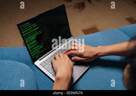 Close-up of programmer developer coding software program script on laptop display, typing keyboard for remote work at home, creating innovative Stock Photo