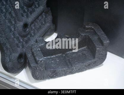 Products made from foamed polymers expanded polypropylene EPP and expanded polystyrene EPS. Model of dense and lightweight material, universal foam. New modern technologies. Industrial manufacturing Stock Photo