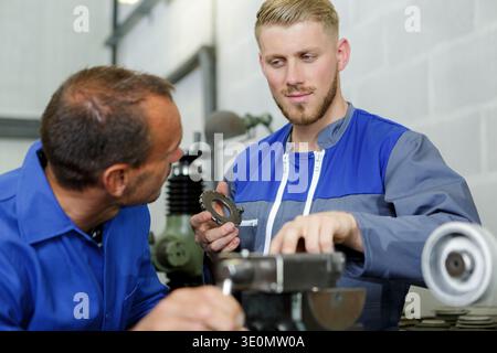 two steel workers checking machine Stock Photo