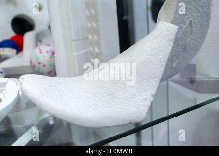 Foam plastic shoe mold. Products made from foamed polymers expanded polypropylene EPP and expanded polystyrene EPS. Model of dense and lightweight material, universal foam. New modern technologies Stock Photo