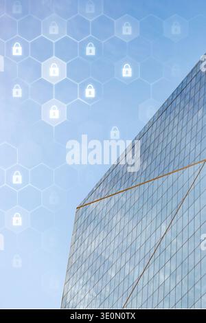 Building with glass facade and security symbols against clear sky backdrop Stock Photo