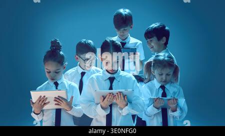 Children using tablets on studio background Stock Photo