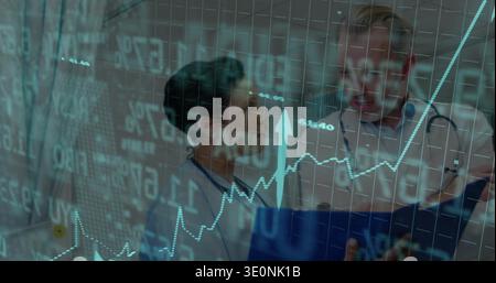 Reviewing two doctors in white coats examining rising chart overlay at clinic ward with stethoscope Stock Photo