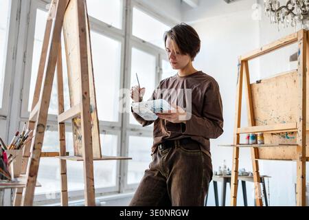 Female artist painting in her studio Stock Photo