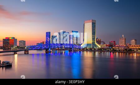 Jacksonville, Florida, USA. Cityscape image of Jacksonville, Florida with reflection of the city skyline in the water at beautiful sunset. Stock Photo