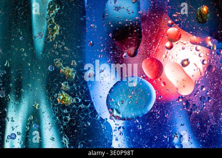 Mesmerizing blue abstract macro featuring oil and water interaction with transparent spheres, creating a calm yet dynamic aquatic texture. Stock Photo