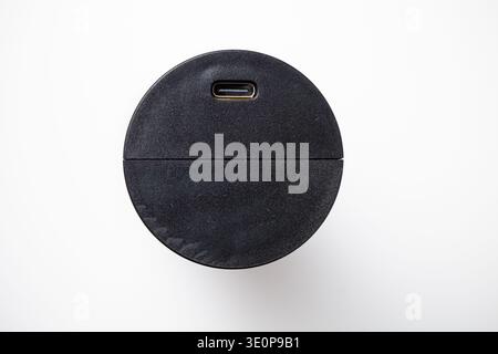 Round Black USB-C Adapter with Matte Finish on White Background. Stock Photo