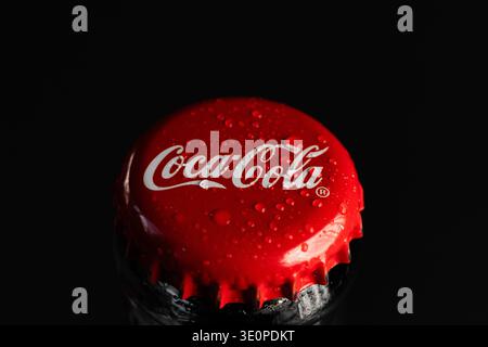 Lviv, Ukraine - March13, 2026: Angled Macro View of a Red Coca-Cola Bottle Cap with Water Drops Stock Photo