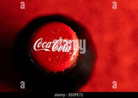Lviv, Ukraine - March13, 2026: Angled Macro View of a Red Coca-Cola Bottle Cap with Water Drops Stock Photo
